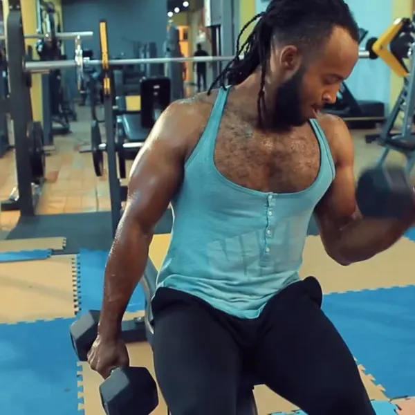 Member performing a dumbbell bicep curl at Power Gym